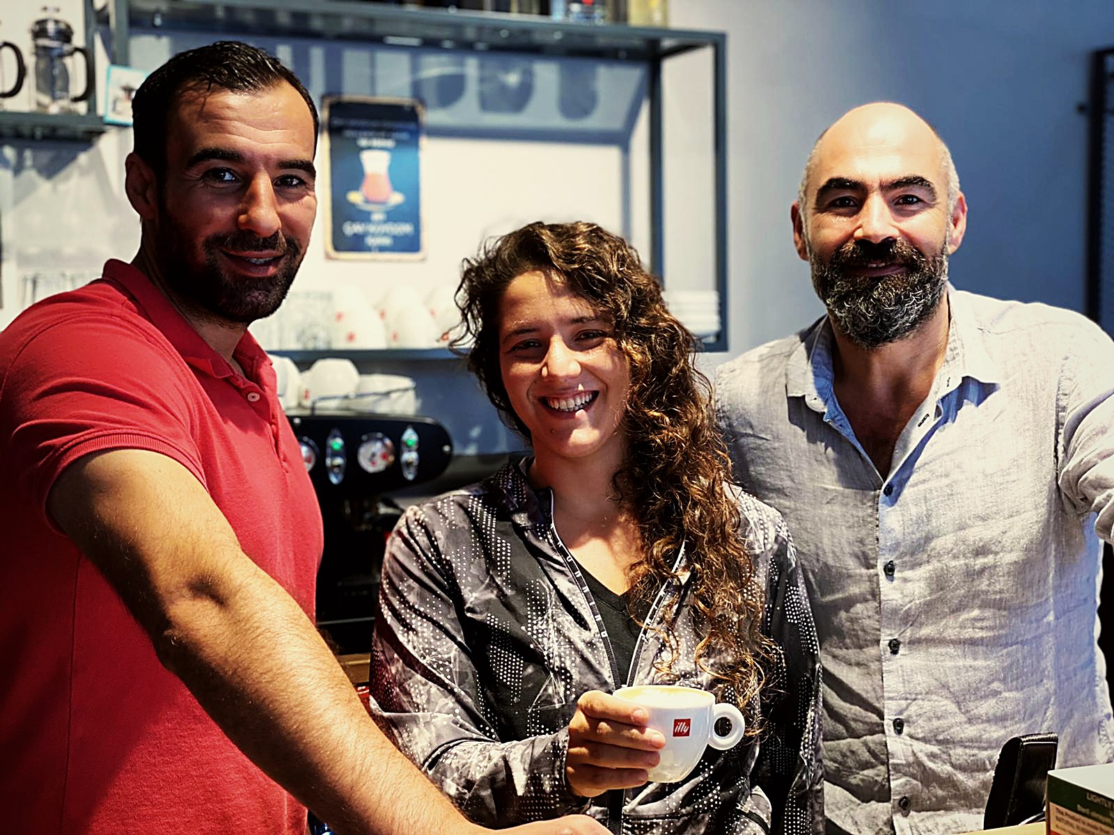 Daniel Sulimani with café team owners after a training session